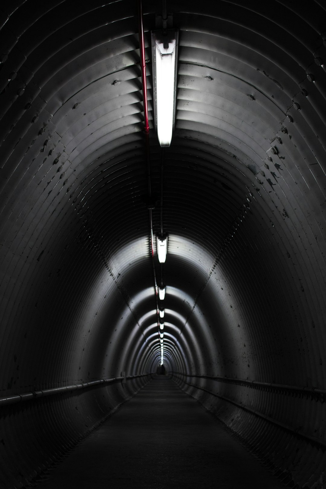 gray-concrete-tunnel-with-light-qpjnkgucg1k